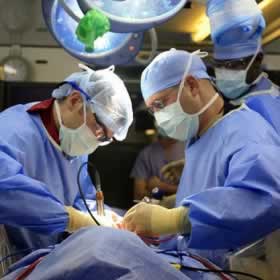Surgeons operating on a patient, operating theatre clean with Bio-spear before operations commence